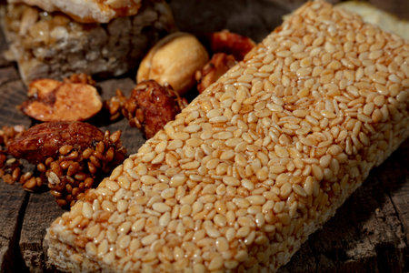 Kozinaki of sesame on the wooden background