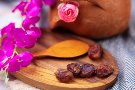 Dried dates on a wooden plateの写真素材