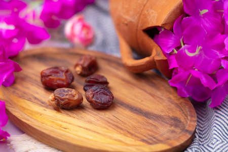 Dried dates on a wooden plateの写真素材