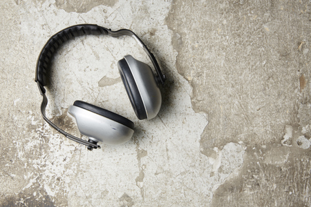 Headphones on cement floor.の写真素材