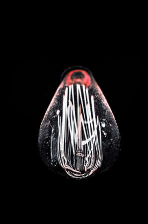 a retro lightbulb against a dark backgroundの写真素材