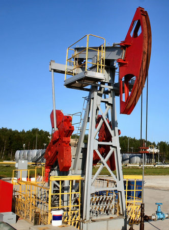 Working pump jack pulling crude oil out of an oil well.