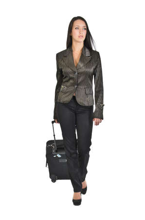 A girl drags a heavy suitcase. Shot on a white background.の写真素材