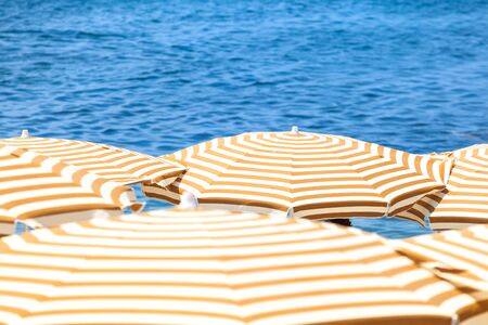 beach umbrellas and cloudy skyの写真素材