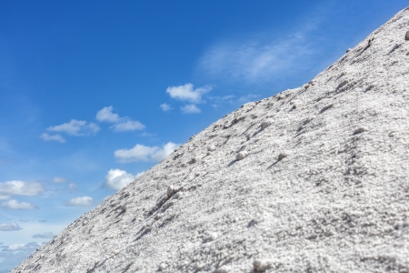 Big pile of freshly mined salt, set against a blue skyの写真素材