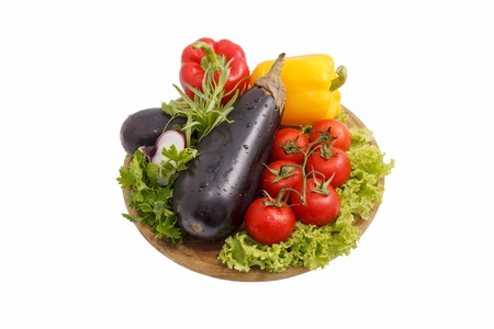 Red, yellow paprika of a paprika, tomatoes and eggplants on a round wooden board. Healthy, food food subject. Top viewの写真素材