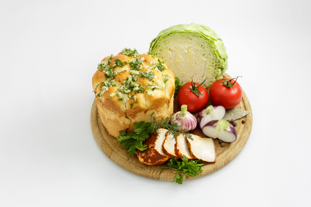 Still life of vegetables with bread on a white backgroundの写真素材