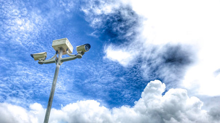 Bottom view shot of surveillance pole on sunny day.