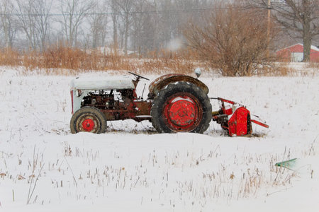 Old Farm Tractor In Winter Field