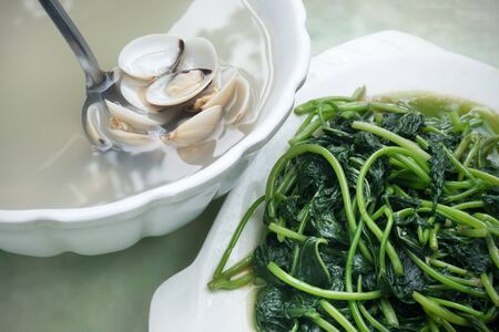soup with mussels and spinach in a Chinese restaurantの写真素材