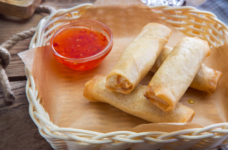 Stuffed pancakes with sauce in a wicker plate