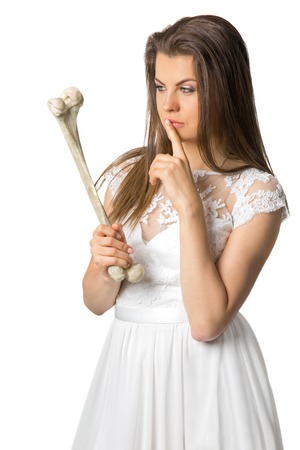 girl in a white dress holding a rib of a man, and thinks on an isolated backgroundの写真素材