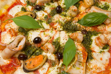Pizza with seafood close-up in restaurantの写真素材