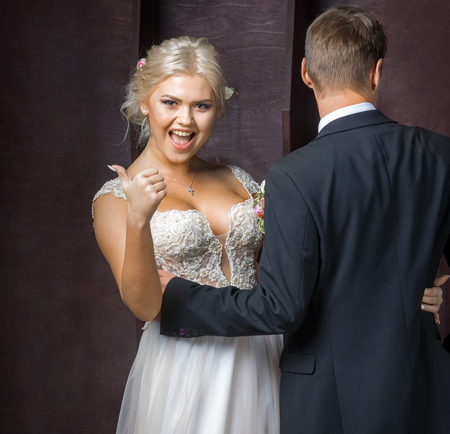 bride rejoices in his good fortune next to the groom in the Studioの写真素材