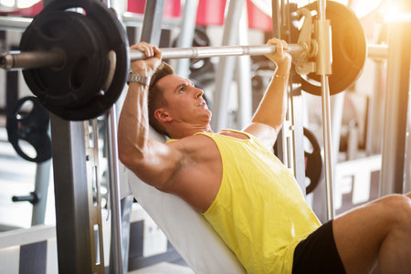 athlete does in the gym with a barbell in gym