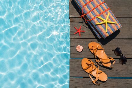 beach accessories on the shore of the pool on a Sunny dayの写真素材