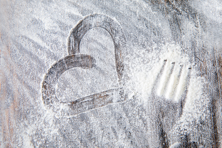 heart of flour on the table in the kitchenの写真素材