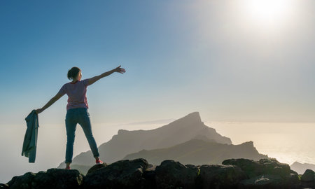 tourists looking at the bright sun and the mountains of Tenerife