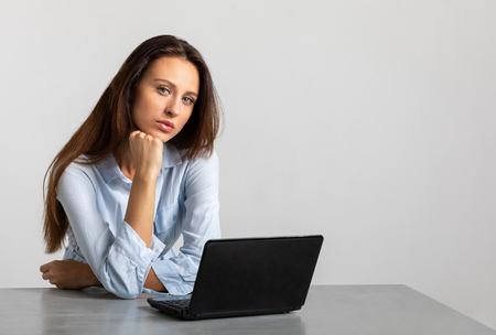 Sad girl tired of working in the office and she looks with despair. office workの写真素材