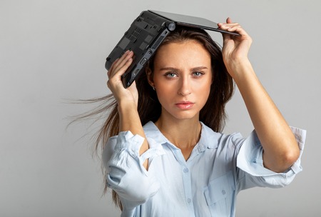 girl with a laptop on her head. office workの写真素材