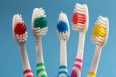 tooth brushes - family set of toothbrushes on color background. different brush colors