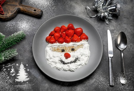decorating and baking for Christmas. Christmas cookies icing decorating process with a pastry bag. figure of Santa Claus on Christmas plateの写真素材