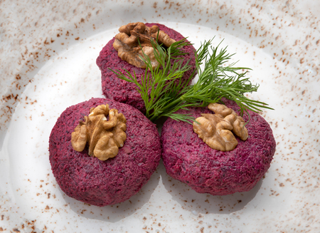 beetroot salad with walnuts on a plate. Beetroot salad with walnuts on white background. restaurant menuの写真素材