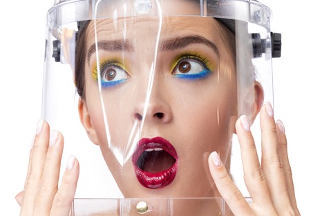 girl in a protective helmet made of plastic in a white isolated Studio. close-up frame. the concept of environment. environmental hazard and fearの写真素材