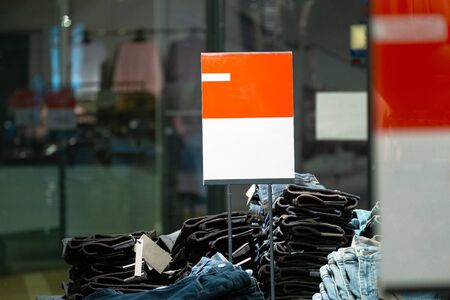 signs with mockup in a clothing store. light industry in clothing stores. sign with white and red backgroundの写真素材