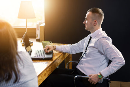 the man works in the office at the computer and decided to relax in his chair. businessman bored...
