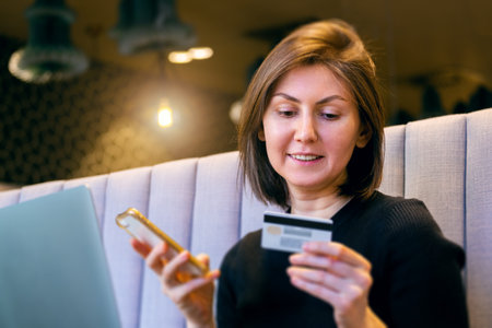 woman with a laptop and a credit card. pays for purchases online