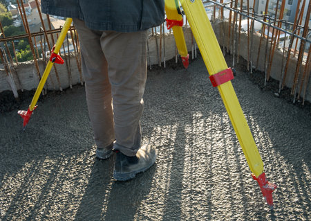 geodesy specialist works on a construction site. tripod and special equipment for geodesy. High...