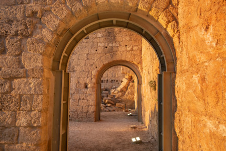 ancient arch with modern metal support from collapse in caesarea israel. in the evening in the light of the setting sunの写真素材