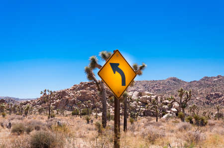 Curve Warning Sign in the desert, USAの写真素材