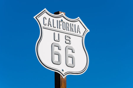 A scenic view of a historic Route 66 sign with a sky blue background, Arizona, USA