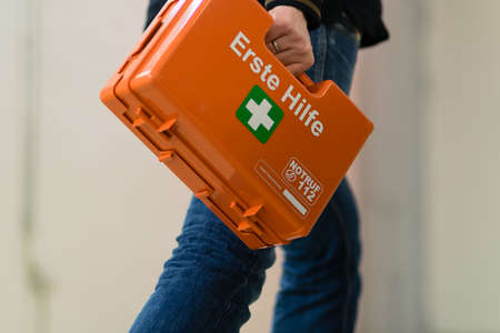 First aid after an accident at work. First responder with first aid kit, Germany.の写真素材