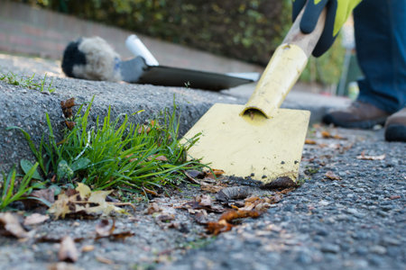 Man is cleaning the street gutter