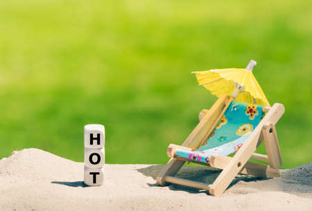 Dice placed next to a beach chair form the wordの写真素材
