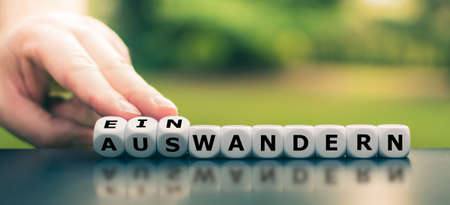 Hand turns dice and changes the German wordの写真素材