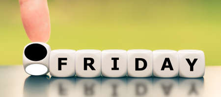 Hand turns a dice and changes the color of a dice from white to black as symbol for the black friday.の写真素材