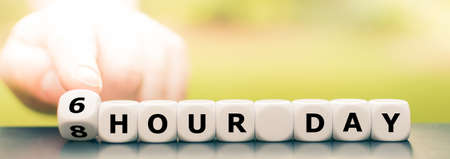Symbol for a six hour workday. Hand turns a dice and changes the expression "8 hour day" to "6 hour day".の写真素材