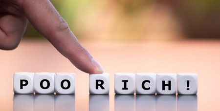 Hand moves dice and changes the word poor to rich.