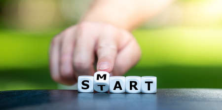 Symbol for being smart in a new life chapter. Dice form the words smart and start.の写真素材