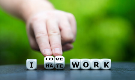 Hand turns dice and changes the expression I hate work to Ilove work.
