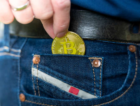 One puts a Bitcoin into the Jean Pocket.の写真素材