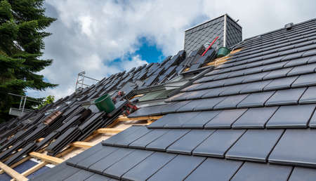 New flat tiles on top of a residential roof.の写真素材