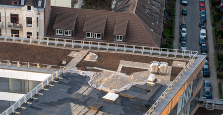 Birds eye view of a roof construction site. Professional placing of gravel stones on a flat roof building.の写真素材