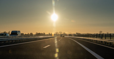Driving into the sun at a German autobahn. Symbol for the danger of looking into sunlight while...
