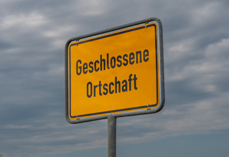 City entrance sign on a road in Germany with the text 'clusive village' (built-up area).の写真素材