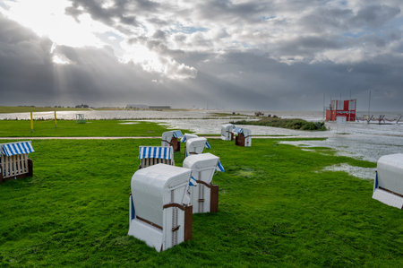 Beach chairs at the beach of Altenbruch near Cuxhaven in Germany. Beach flooded after a summer storm in August 7th 2023.の写真素材